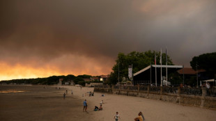 Tens of thousands in France flee burning holiday haven, by road and sea