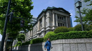 Bank of Japan holds rates, will slow bond purchase taper